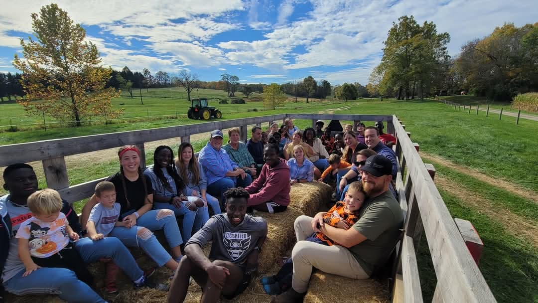 A group riding together on a farm haywagon